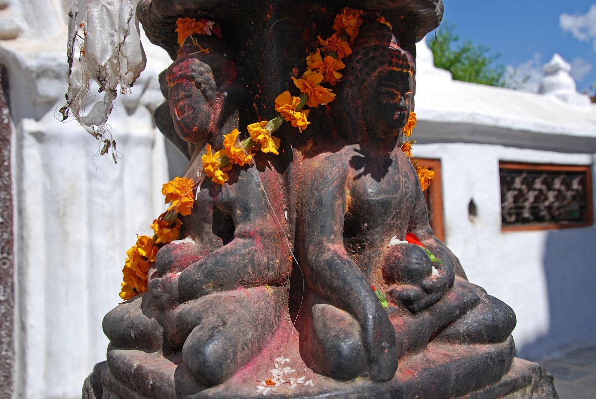 Kathmandu Boudhanath 07-1 Dhyani Buddha Statues At Boudhanath Entrance A set of four Dhyani Buddhas carved in one piece of stone greets you just after entering the Boudhanath Stupa near Kathmandu. On the left is Amitabha, the Dhyani Buddha of the west, and on the right Ratnasambhava, the Dhyani Buddha of the south.